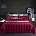 Ensemble de literie quatre pièces style hôtel, en coton à fibres longues (100s), coloris uni, comprenant une housse de couette et un drap-housse.