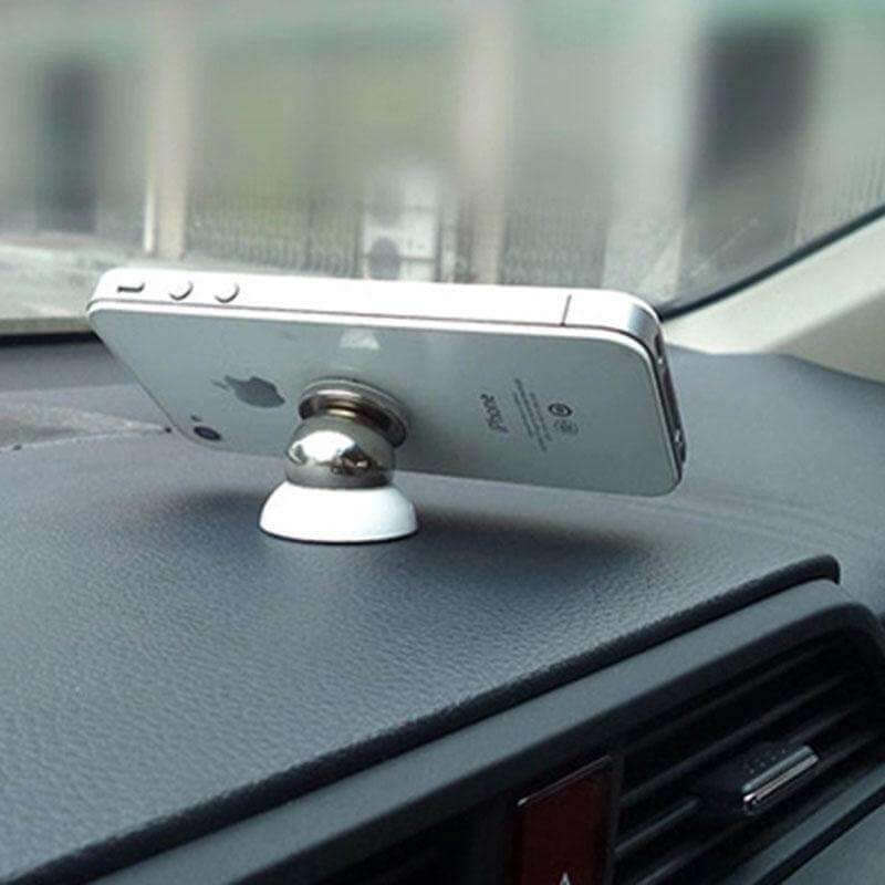 Magnetic Car Cell Phone Holder Mount Dash 360 Rotating For iPhone GPS holding a smartphone on a car dashboard.