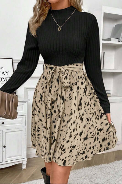 Ribbed Knit Patchwork Printed Belted A-line Dress showcasing a black ribbed top and a spotted beige skirt.