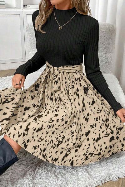 Ribbed Knit Patchwork Printed Belted A-line Dress in black and beige sitting on a white rug.