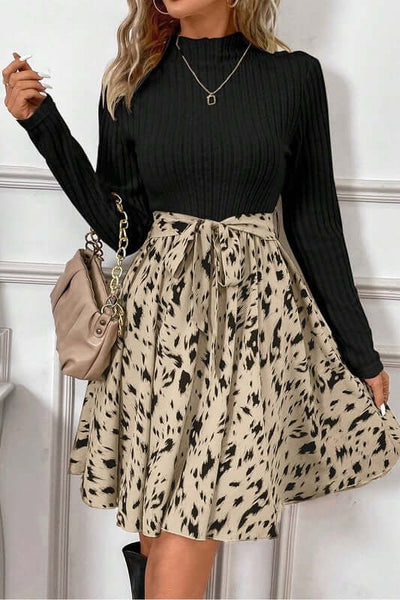 Ribbed Knit Patchwork Printed Belted A-line Dress featuring a black top and a patterned beige skirt.