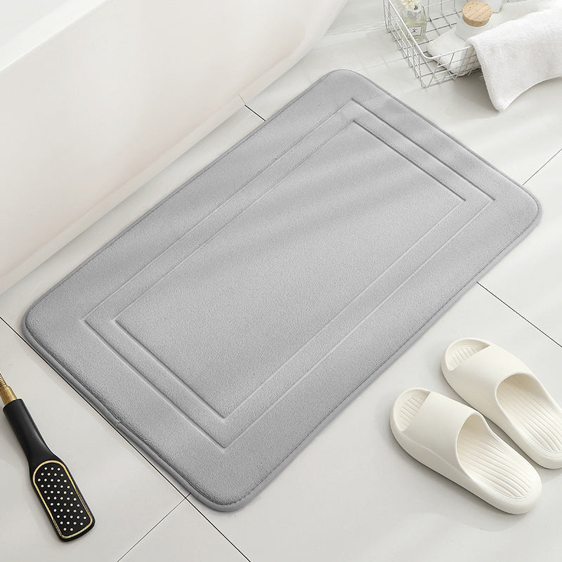 Tapis de sol absorbant antidérapant et moderne en éponge pour porte de salle de bain minimaliste.