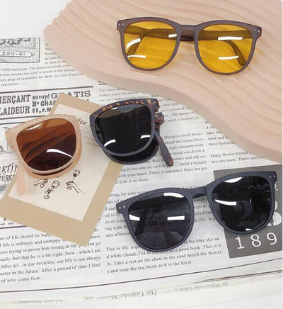 Trendy Foldable Sunglasses For Women TR Polarized Folding Sun Glasses displayed on a wooden surface.