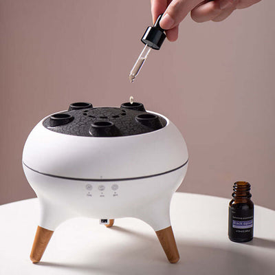 Dynamic Jellyfish Air Humidifier – 250ml Ultrasonic Diffuser with Remote & 7-Color LED Lights in use adding essential oil.