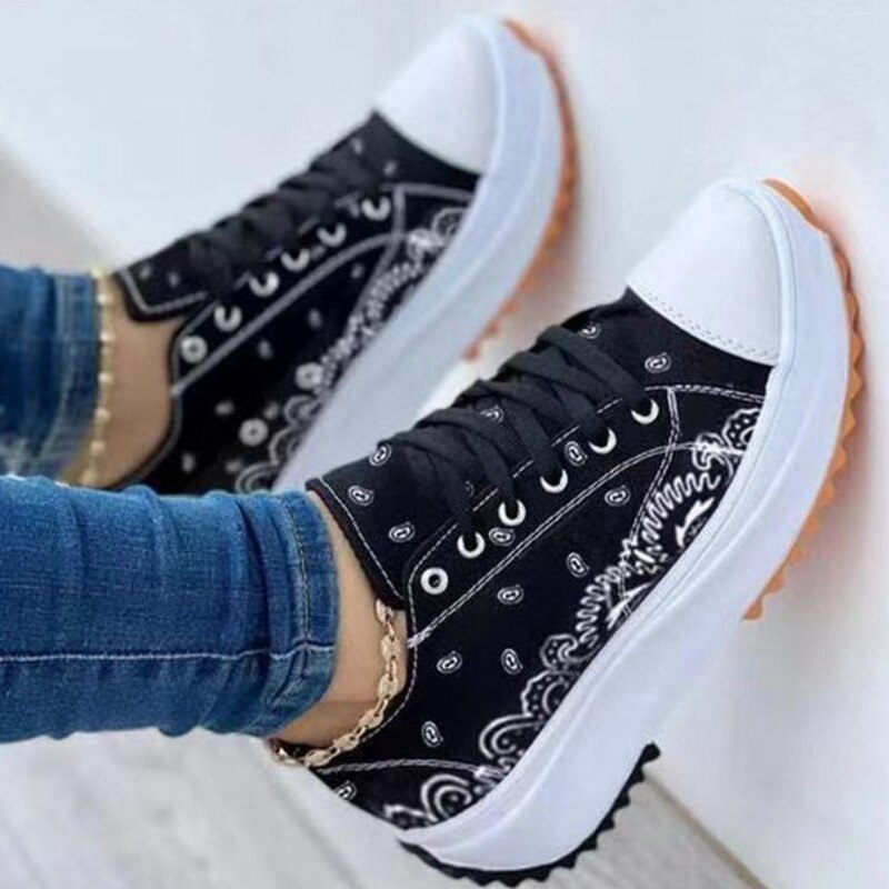 Pattern Canvas Women Sneakers Casual Sport Shoes on a woman's feet with denim, featuring a stylish black and white pattern.