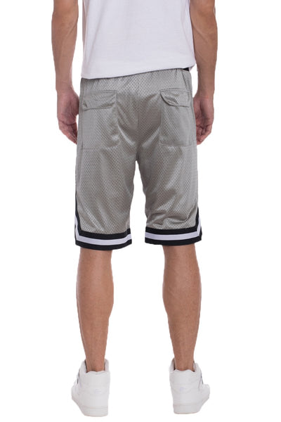 Back view of man wearing solid mesh basketball active shorts with side pockets and sporty design.