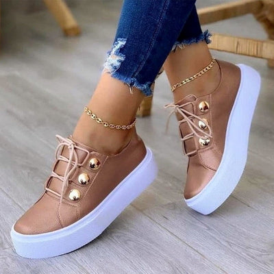 Light Breathable Female Running Shoes Casual Women Sneakers in stylish design with gold buttons and white sole.