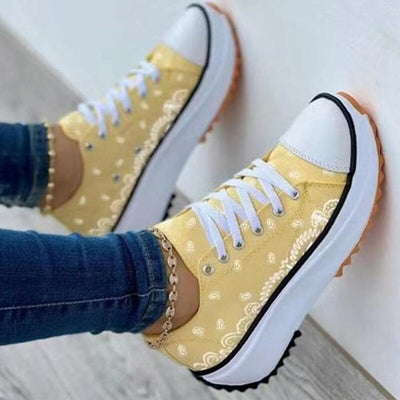 Pattern Canvas Women Sneakers Casual Sport Shoes in yellow with white accents, styled with jeans.