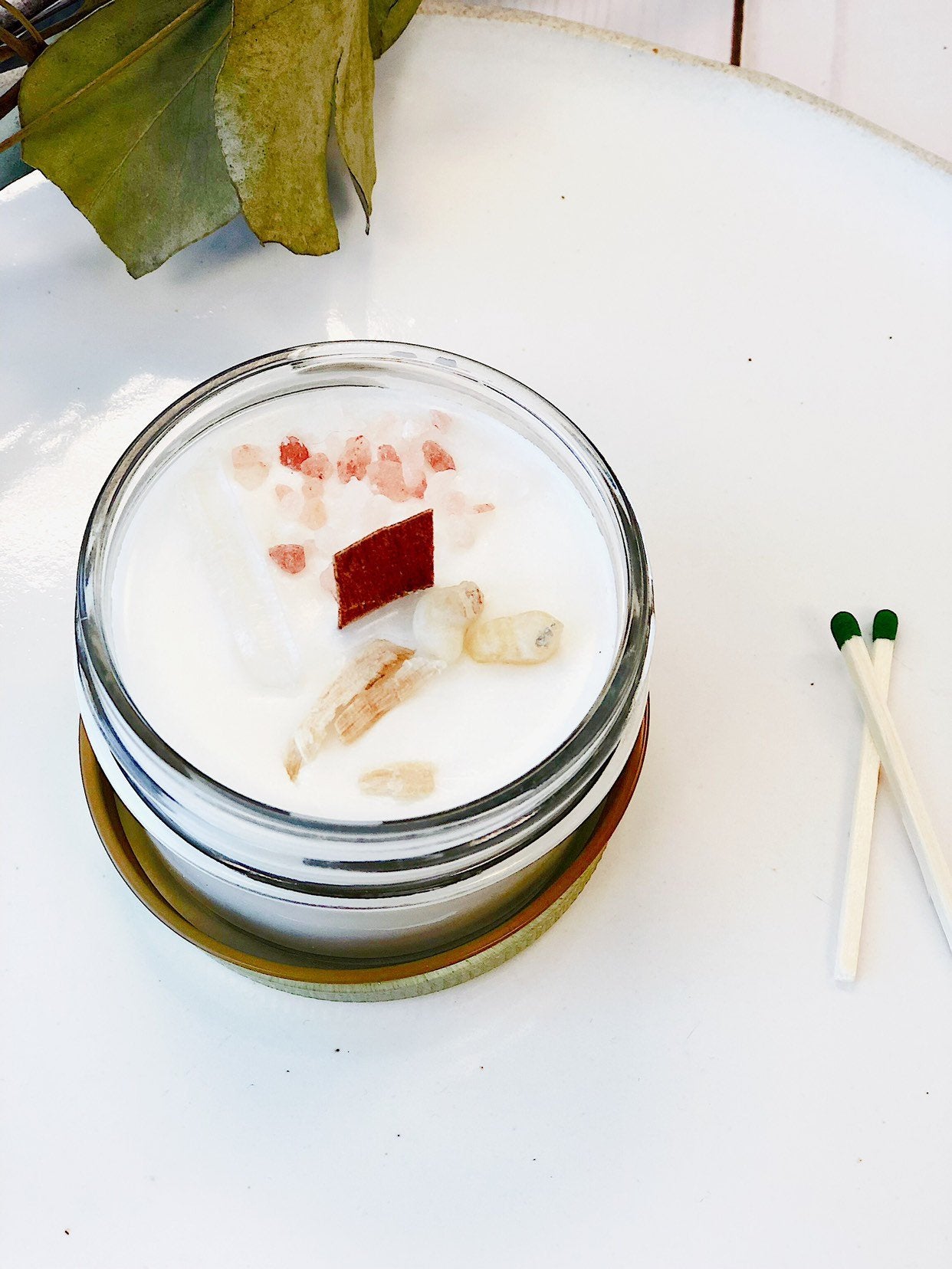 Space clearing intention candle made with organic soy wax, featuring herbs and crystals for cleansing energy.