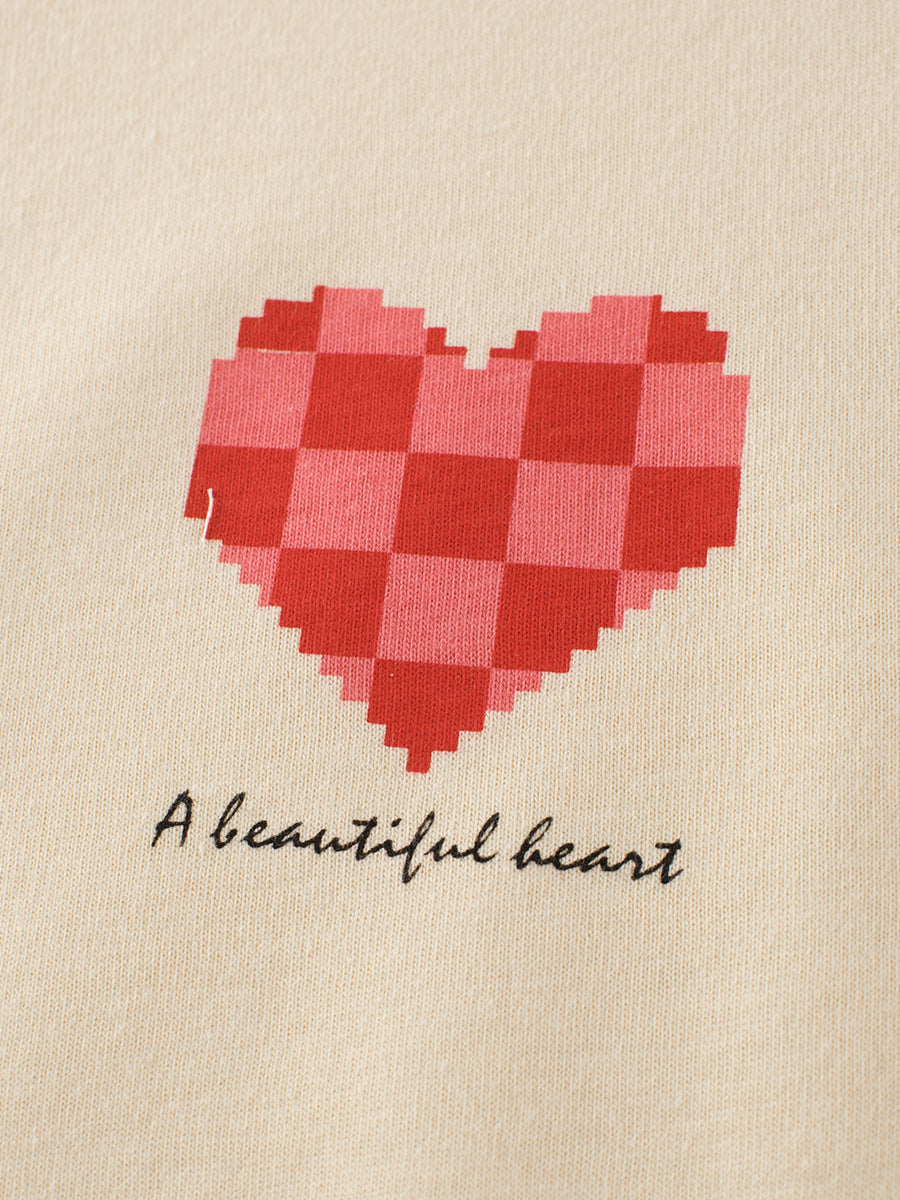 Plaid Red Heart Printing Girls’ T-Shirt In European And American Style, showing a red plaid heart design on beige fabric.