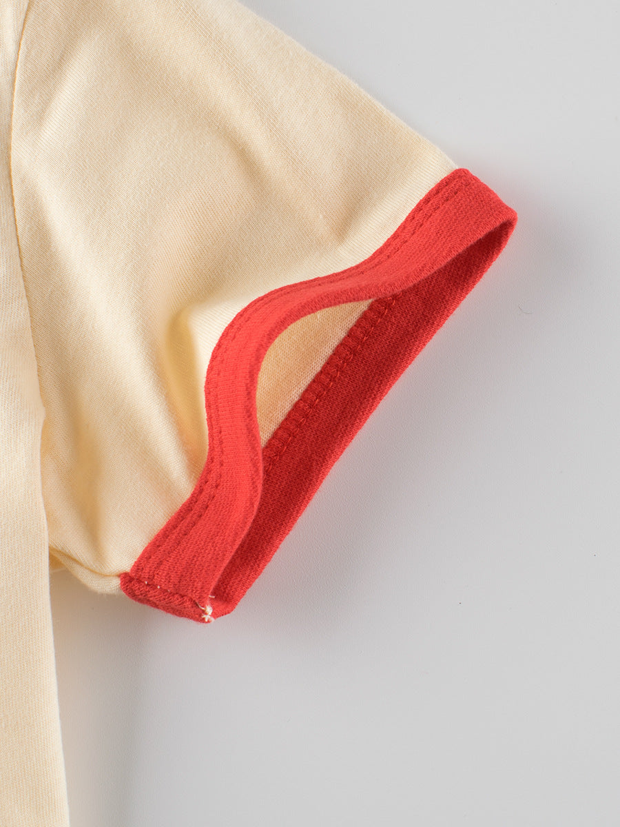 Detail of plaid red heart printing girls’ t-shirt in European and American style with red cuffs and beige fabric.
